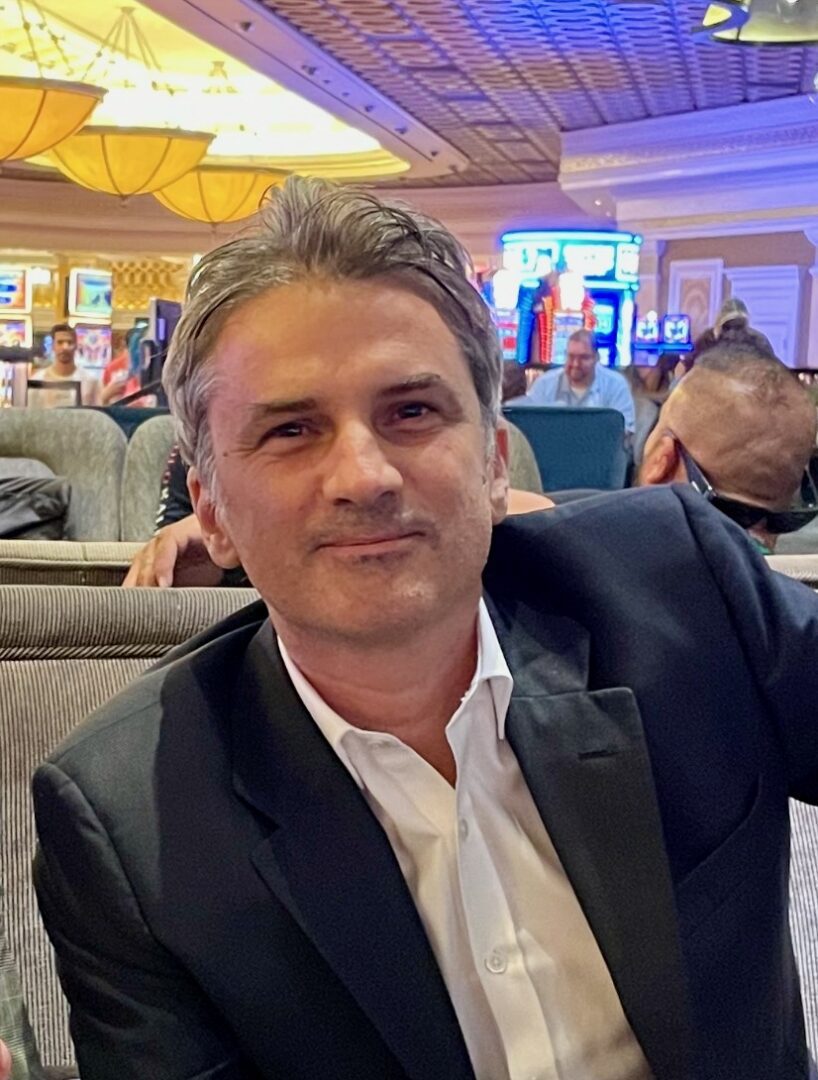 Man in a suit sitting in a restaurant.